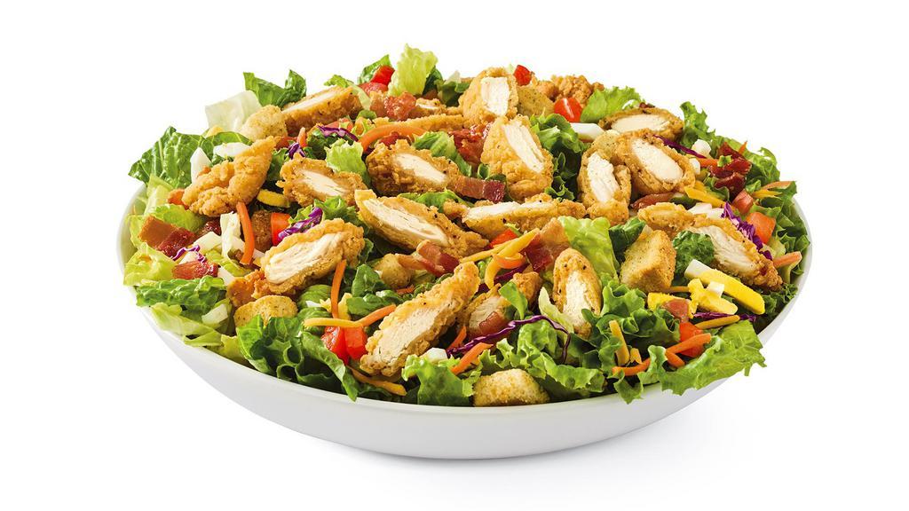 Crispy Chicken Tender Salad · Chicken tenders, hard-boiled eggs, hardwood-smoked bacon, tomatoes, croutons and Cheddar on mixed greens. Served with choice of dressing.