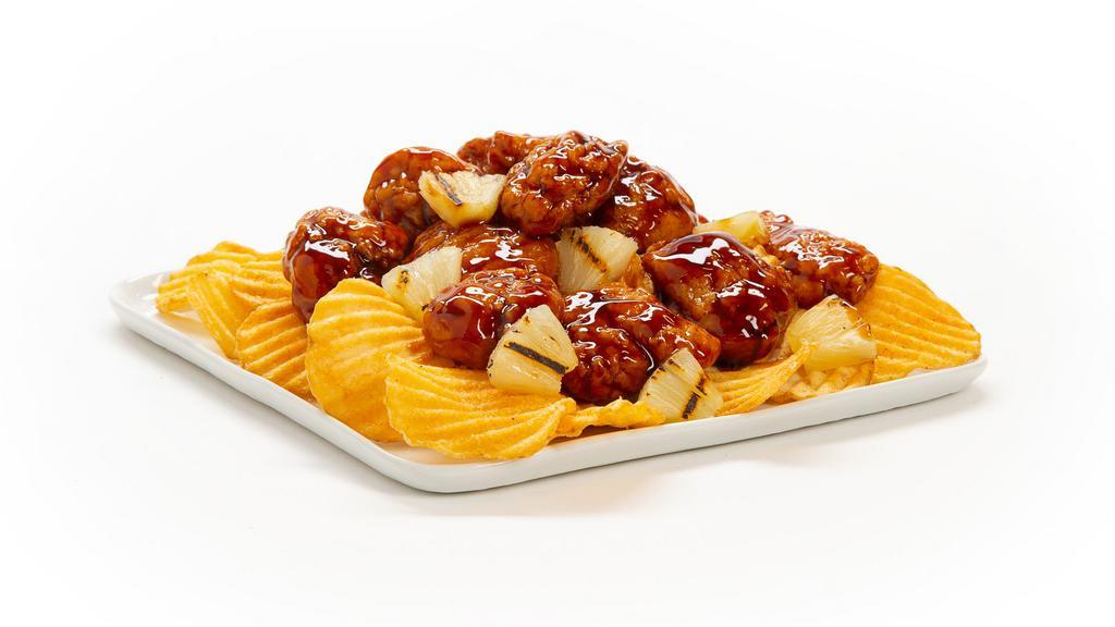 Teriyaki Boneless Wings · Tender and crunchy all-white chicken meat tossed in Teriyaki sauce with grilled pineapple pieces, served on a bed of kettle chips.