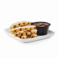 Kids' Grilled Chicken Strips · Bite-sized strips of grilled chicken breast with a side of dipping sauce.
