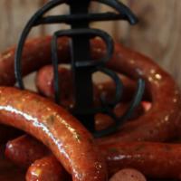 Jalapeno Cheddar · Cousins Hand-Crafted Jalapeno Cheddar Sausage. Made with Beef and Pork.