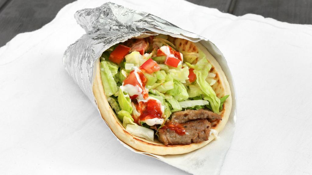 Gyro Wrap · Sliced lamb, pita bread, lettuce, tomatoes, cucumbers, white (tzatziki) sauce, and hot (spicy) sauce.