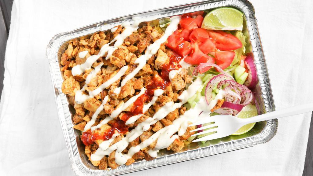 Chicken Shawarma Over Rice · Slices of grilled chicken breast, basmati rice, lettuce, tomatoes, cucumbers, red onions, pickles, feta cheese, white (tzatziki) sauce, and hot (spicy) sauce.