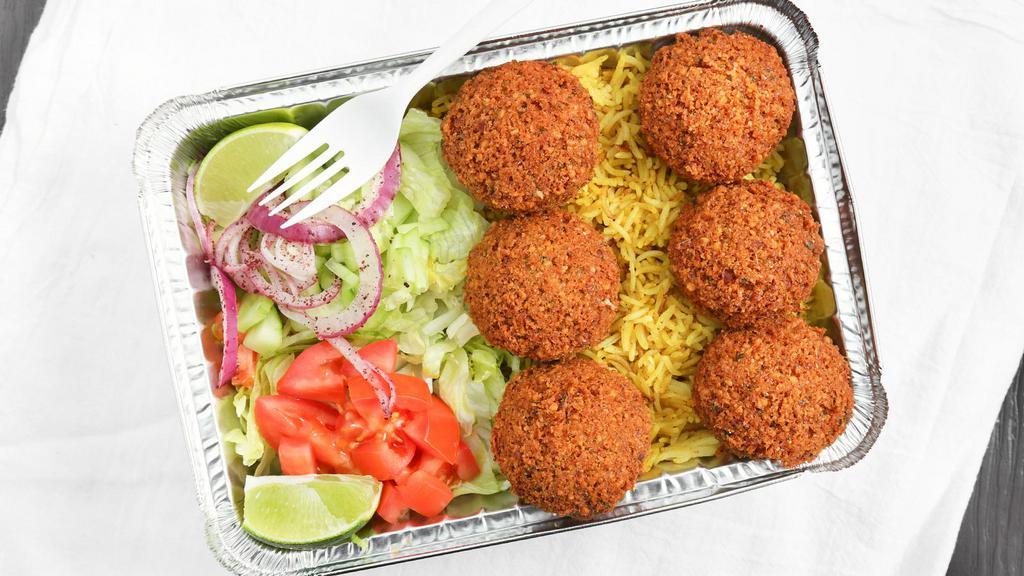 Falafel Over Rice · Falafel, basmati rice, lettuce, tomatoes, cucumbers, red onions, pickles, feta cheese, white (tzatziki) sauce, and hot (spicy) sauce.