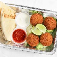 Falafel · Four pieces of falafel, lettuce, white (tzatziki) sauce, and hot (spicy) sauce.