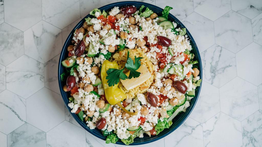 Rice Bowl · Rice Pilaf with Shredded Lettuce, Tomatoes, Red Onions, Cucumbers, Marinated Garbanzo Beans, Kalamata Olives, and Crumbled Feta served with Tzatziki Sauce