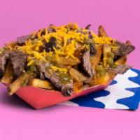 Asada Fries · French fries topped with carne asada beef, salsa verde, and shredded cheese.