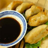 Gyoza (Chicken) · Pot sticker style chicken dumpling, fried and served with ponzu sauce.