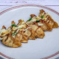 Fried Chicken Gyoza (6) · Crispy chicken and vegetable Gyoza topped with sweet soy sauce, mayo, and green onions.