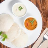 Idli Sambhar (V) (G) · Steamed rice and lentil savory cakes (3). Served with a bowl of lentil and vegetables stew (...