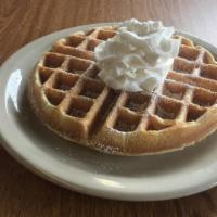 Belgian Waffle · A freshly baked Belgian waffle topped with whipped butter.