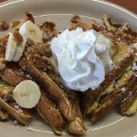 Banana Nut French Toast · Sliced bananas and chopped walnuts.
Topped with powdered sugar and whipped cream.