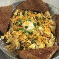 Hurst Skillet · Scrambled with chopped bacon, crumbed sausage, hash-browns and cheddar cheese. topped with s...