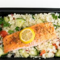 Salmon On Cauliflower Rice · Baked lemon garlic salmon served over cauliflower rice tabbouleh (parsley, cherry tomato and...