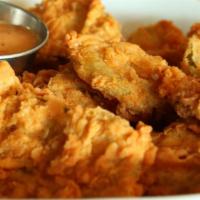 Fried Pickles · Thick cut kosher pickles battered and deep fried served with a side of spicy aioli and ranch...