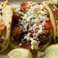 Fish Tacos · A trio of street tacos filled with blackened cod with lime crema, cojita cheese and jalapeno...
