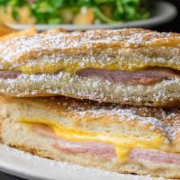 Monte Cristo · A sandwich of ham, turkey, Swiss and American cheeses deep fried and sprinkled with powdered...