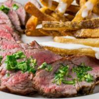Steak Frites · Skirt steak cooked to order seasoned with smoked sea salt and cilantro pesto, served with ho...