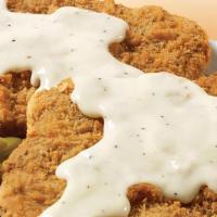 Mega Country Fried Steak Platter · Two of our country fried steaks smothered with white pepper gravy. Served with 2 large sides...