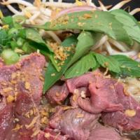 Pho Noodle Soup                                                · Beef soup with thin rice noodles, meatballs, served with a side of fresh basils, bean sprout...