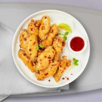 Sweet Chili Wings · Fresh chicken wings breaded, fried until golden brown, and tossed in teriyaki and sweet chil...
