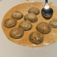 Stuffed Mushrooms · Mushroom caps stuffed with crabmeat and a herb mixture in a pink vodka sauce