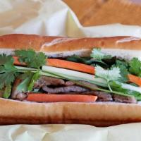 Banh Mi · Toasted Baguette spread with butter and mayo with cucumbers, pickled carrots, jalapenos and ...