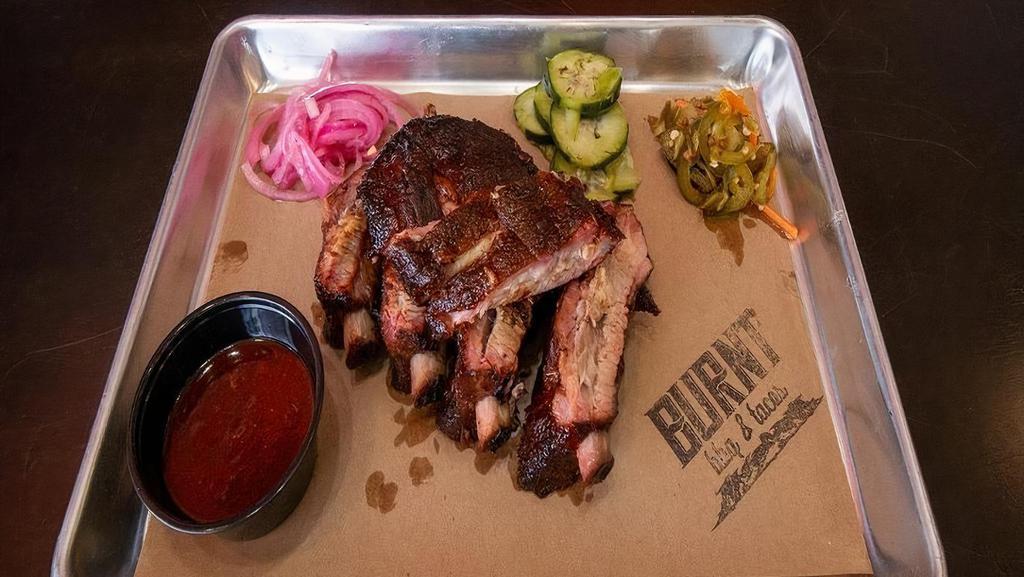 Louis Pork Rib Single · Our St. Louis Style Ribs are smoked for 4.5 hrs  rubbed with Tim's Texas 2 Step BBQ Citrus Rub, then Glazed with our BBQ Sauce.