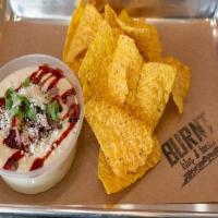 Brisket Queso · You guest it! Brisket, Cheese, Cilantro, Bbq Sauce, Cotija Cheese with house made tortilla c...