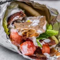 Gyro Sandwich · Thin cuts of Gyro, tomato, lettuce and onion marinated in sumac wrapped in pita bread with y...