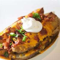 Loaded Potato Wedges · Roasted Garlic & Herb Potato Wedges loaded with Cheddar Cheese, Chives, Bacon & a side of So...