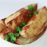 Potato Wedges · Roasted Potato Wedges tossed on our Roasted Garlic and Herb seasoning
