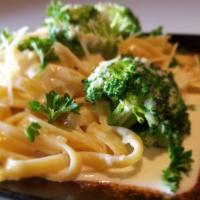 Alfredo Pasta · Creamy Parmesan sauce topped on Fettuccine pasta. Served with French Bread & Butter.