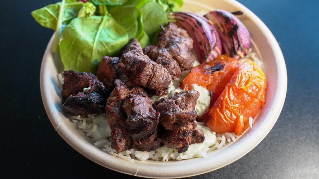 Lamb Kabob Plate · Basmati Saffron Rice | Grilled Lamb | Lettuce | Tomatoes | Pickles | Onions | Tzatziki Sauce | Tahini Salad