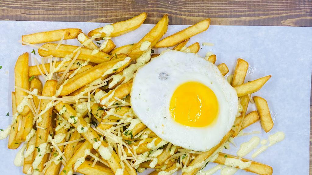 Truffle Breakfast Fries · French fries, parmesan cheese, truffle oil, fried egg on top.