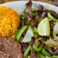 Ranchero Plate · Skirt steak grilled with bell peppers and onions. Served with rice and beans. Flour or corn ...