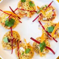 Sev Puri · Crispy puris topped with assorted chutneys and sev.