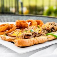 Philly Cheesesteak Sandwich · Shaved ribeye steak, sautéed onions and peppers with cheez whiz on a toasted hoagie roll.