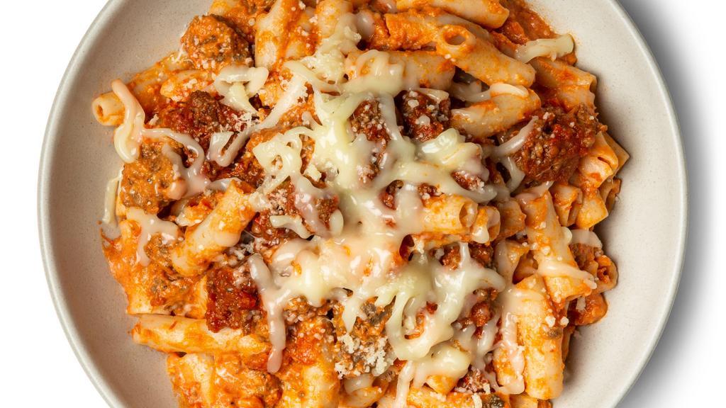 Baked Ziti With Italian Beef Sausage · So deliciously cooked to perfection and you can almost taste it. Gluten-free brown rice penne, coated in rich tomato sauce, Italian seasoned grass-fed beef sausage, ricotta, mozzarella cheese, parmesan cheese, crushed red pepper, and Italian herbs.