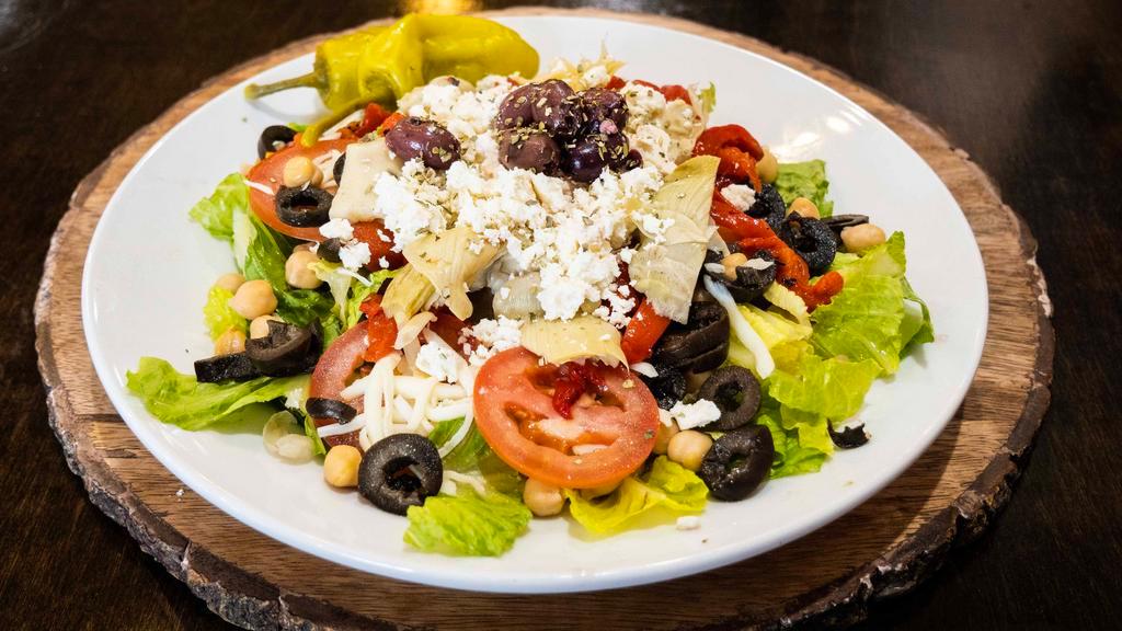 Greek Salad · Romaine Lettuce, Tomatoes, Chickpeas, Sweet Peppers, Artichokes, Pepperoncini, Feta Cheese &  Kalamata Olives.