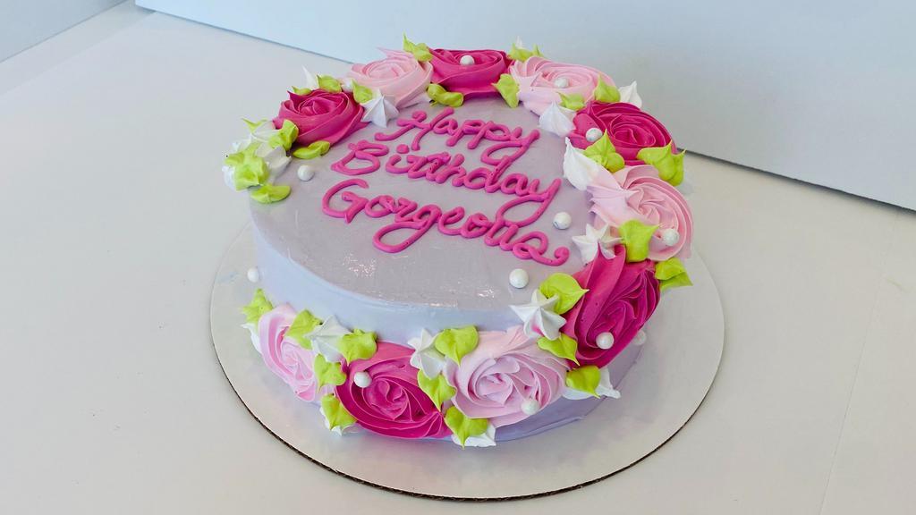 Happy Birthday Gorgeous Cake · 7-inch round cake, serves 10-12. Delicious strawberry and cheesecake froyo layers on a white/vanilla cake base, with a luscious filling of caramel sauce and cheesecake bites. Decorated with a splash of beautiful icing flowers! Please call the store at 469-454-6797 to confirm availability BEFORE ordering.