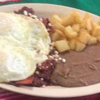 Huevos Charros · 2 fried eggs covered in charros beans, served with queso fresco and avocado.