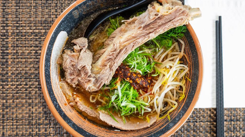 Spicy Beef Ramen · A hearty beef broth with a shoyu base. Toppings: Daikon radish, scallions, cilantro, braised beef brisket, a large beef back rib (so tender it literally falls right off the bone), a house mild spicy paste, and a lime.