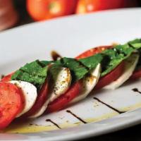 Insalata Caprese · (900 cal). Perfectly ripened Roma tomatoes, fresh mozzarella, and garden-fresh basil, drizzl...