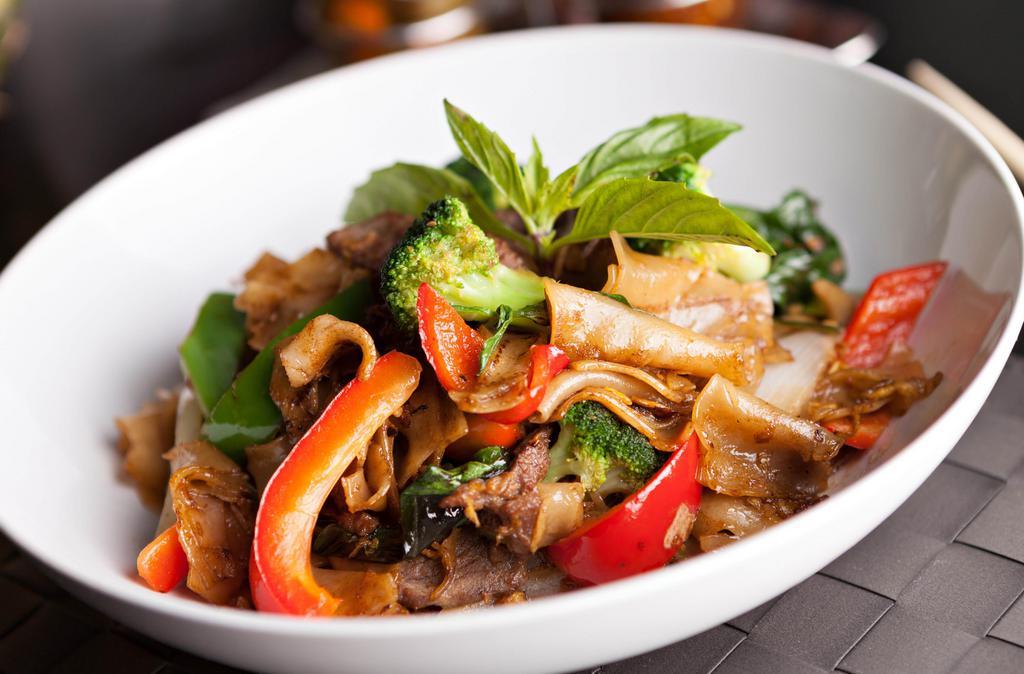 Pad Kee Mow · Minced chicken, tomatoes, carrots, onions, bell peppers, and fresh basil stir fried with big flat noodles