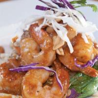 Rama Peanut Stir-Fry · Marinated sliced chicken in homemade peanut sauce topped on a bed of seasoned cabbage, carro...