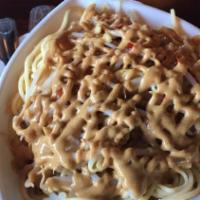 Sesame Cold Noodles · Sesame/peanut sauce over noodles, garnished with thin sliced chilies.