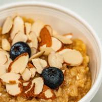 Grandma'S Oatmeal · Old fashioned cinnamon oats topped with shaved almond, blueberry, and drizzled honey.