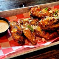 Grilled Latin Wings · 8 Grilled Wings tossed in a Sriracha Honey Sauce.