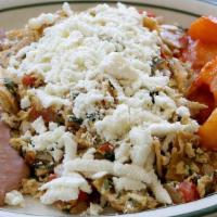 Migas · Scrambled eggs with cut corn tortillas, onions, tomatoes, and jalapeño. Topped with queso fr...
