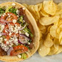 Greek Gyro · Sliced gyro meat served on a pita with lettuce, tomatoes, onions, Feta and cucumber sauce.